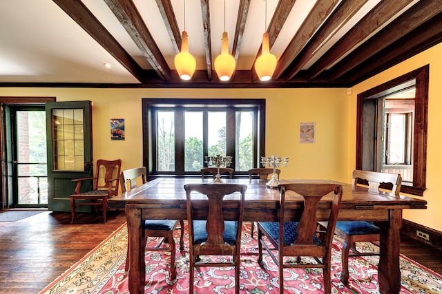 dining space featuring crown molding, hardwood / wood-style flooring, and beamed ceiling