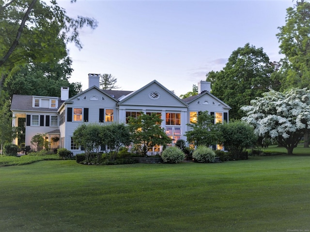 greek revival inspired property featuring a front yard