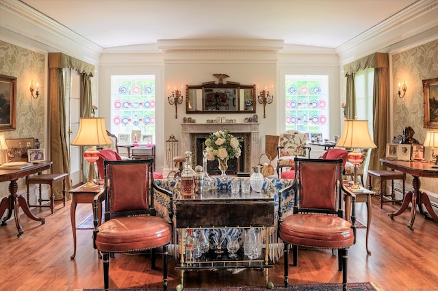 living area featuring hardwood / wood-style flooring, crown molding, and plenty of natural light