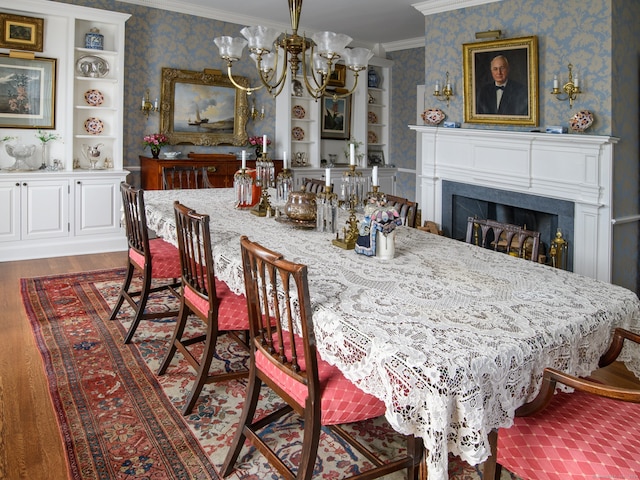 dining space with ornamental molding, dark hardwood / wood-style floors, and a chandelier