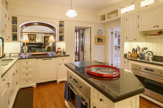 kitchen with pendant lighting, white cabinetry, stainless steel appliances, and dark wood-type flooring