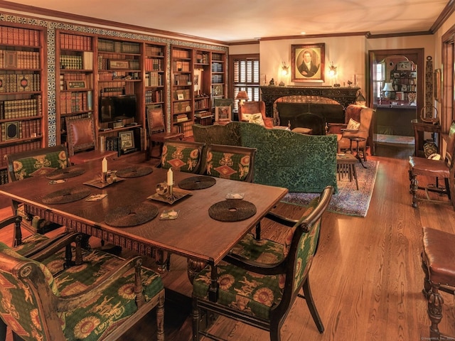 dining space with crown molding and hardwood / wood-style floors