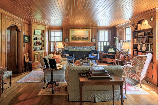 living room featuring wood ceiling, ornamental molding, wood-type flooring, and wood walls