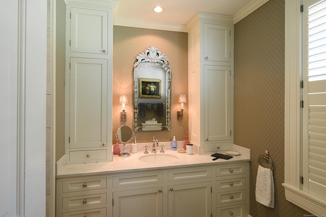 bathroom featuring crown molding and vanity