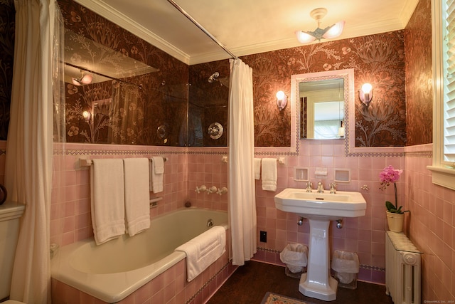 bathroom featuring ornamental molding, radiator heating unit, shower / bath combo with shower curtain, and tile walls