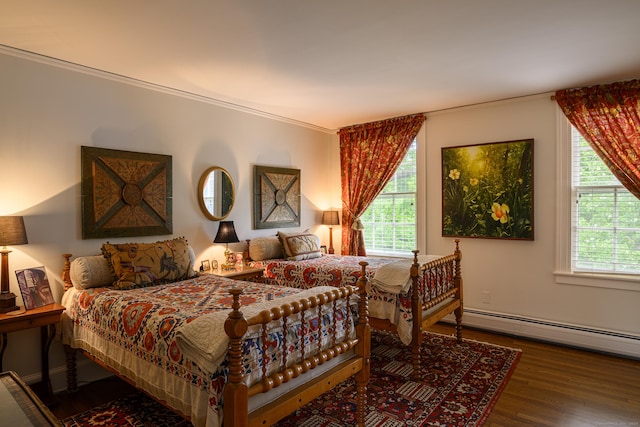 bedroom with hardwood / wood-style floors, a baseboard radiator, and ornamental molding