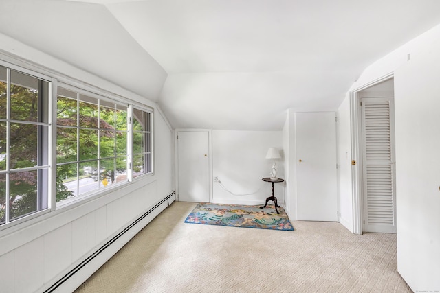 bonus room with vaulted ceiling and a baseboard heating unit