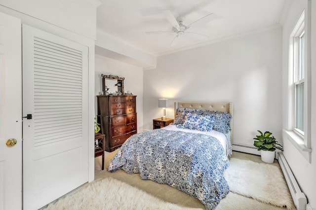 carpeted bedroom with baseboard heating, ceiling fan, and ornamental molding