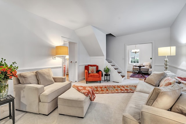 carpeted living room with an inviting chandelier