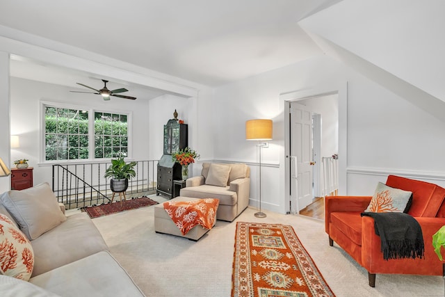 carpeted living room featuring vaulted ceiling and ceiling fan