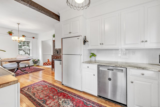 kitchen featuring pendant lighting, an inviting chandelier, white refrigerator, stainless steel dishwasher, and white cabinetry