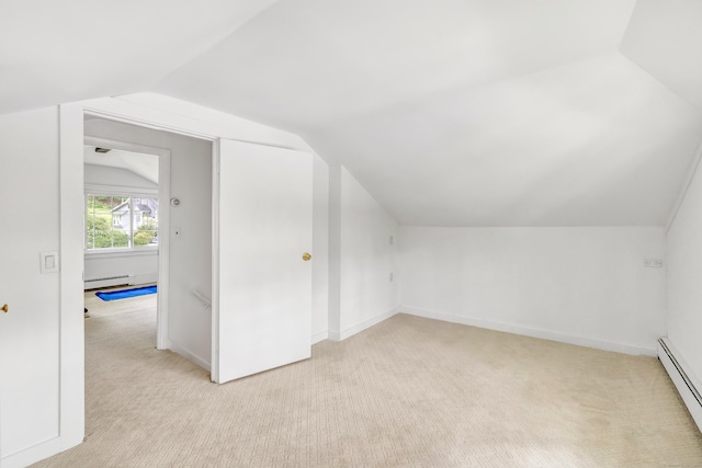 bonus room featuring a baseboard radiator, vaulted ceiling, and light colored carpet