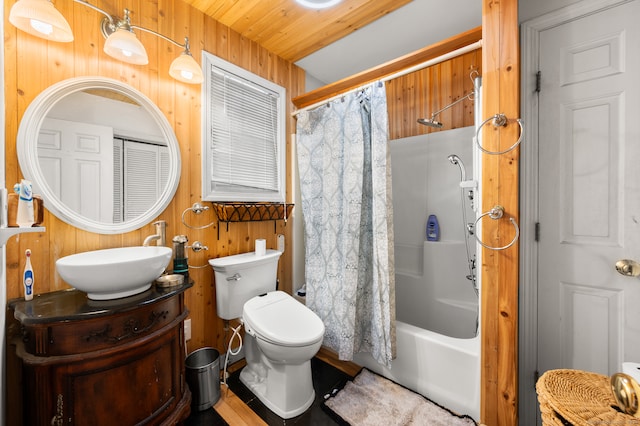 full bathroom with shower / bathtub combination with curtain, wooden walls, vanity, and toilet