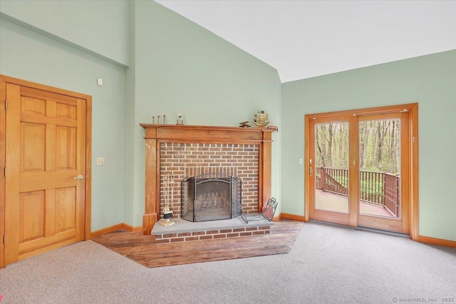 living room with a fireplace, carpet floors, and lofted ceiling