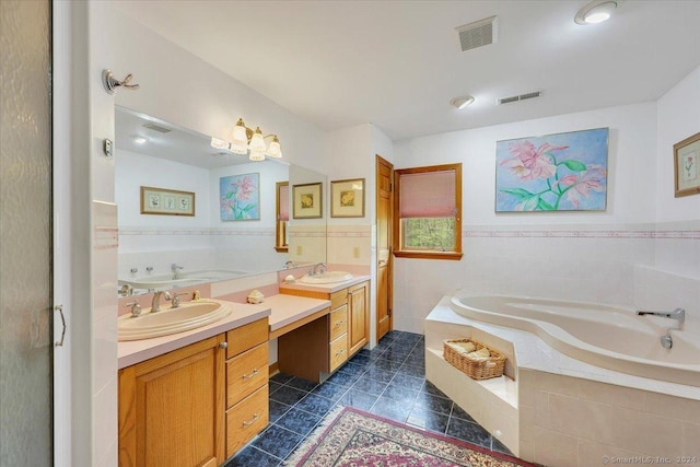 bathroom with tile patterned floors, tiled bath, vanity, and tile walls