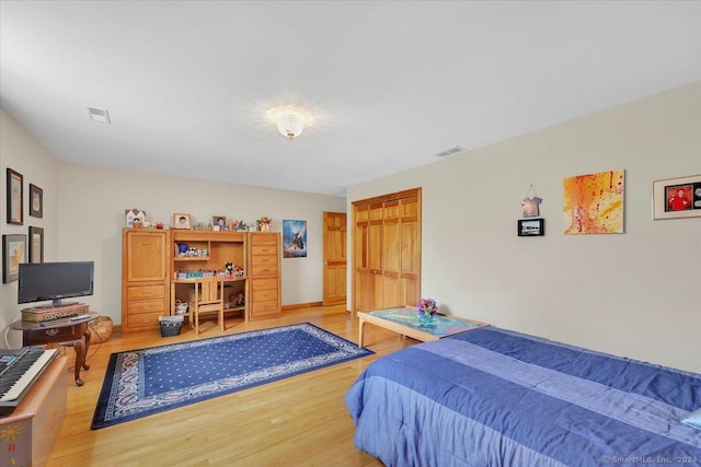 bedroom featuring light hardwood / wood-style floors and a closet