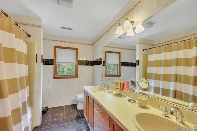 bathroom featuring vanity, toilet, tile walls, and curtained shower