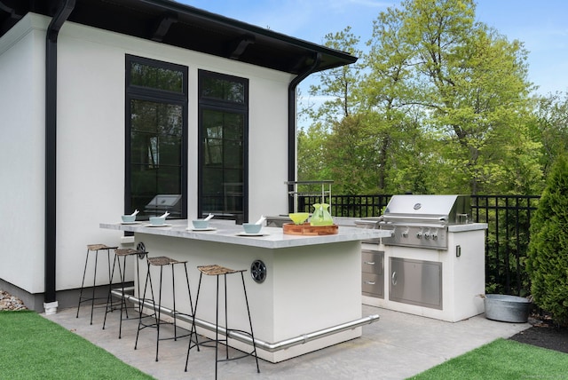 view of patio / terrace featuring area for grilling and exterior bar