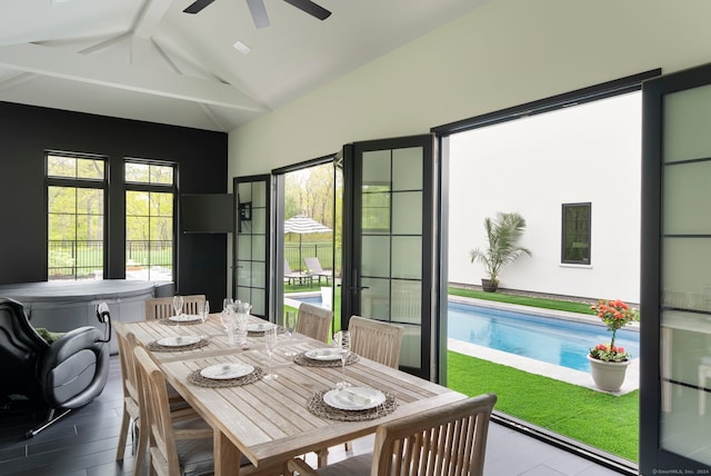 interior space with vaulted ceiling with beams and ceiling fan