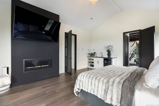 bedroom featuring lofted ceiling with beams and wood-type flooring