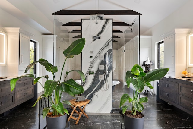 interior space with beamed ceiling, a wealth of natural light, and dark tile floors