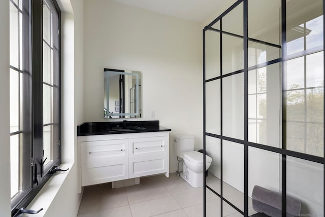 bathroom with tile floors, oversized vanity, and toilet