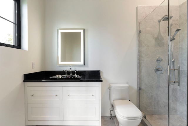 bathroom with an enclosed shower, vanity, and toilet