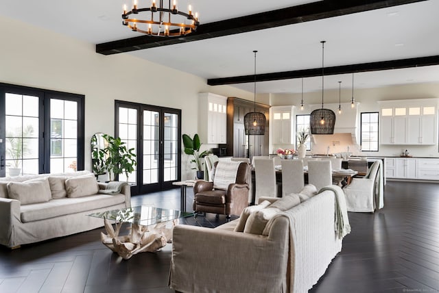 living room featuring beamed ceiling, a notable chandelier, and french doors