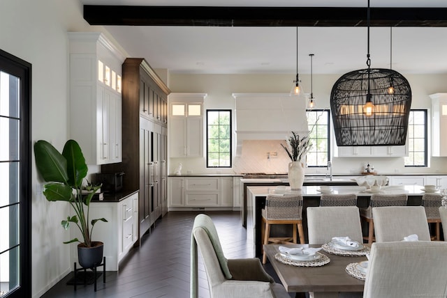 dining area featuring sink, dark parquet flooring, and a wealth of natural light