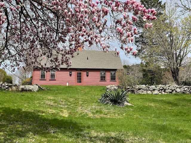 rear view of property with a yard