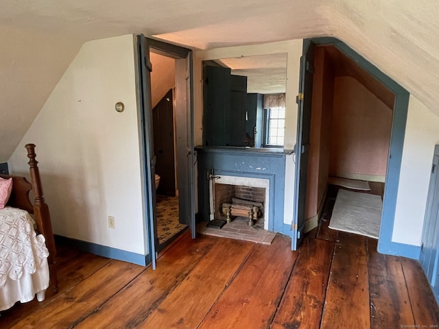 interior space featuring dark hardwood / wood-style floors and vaulted ceiling