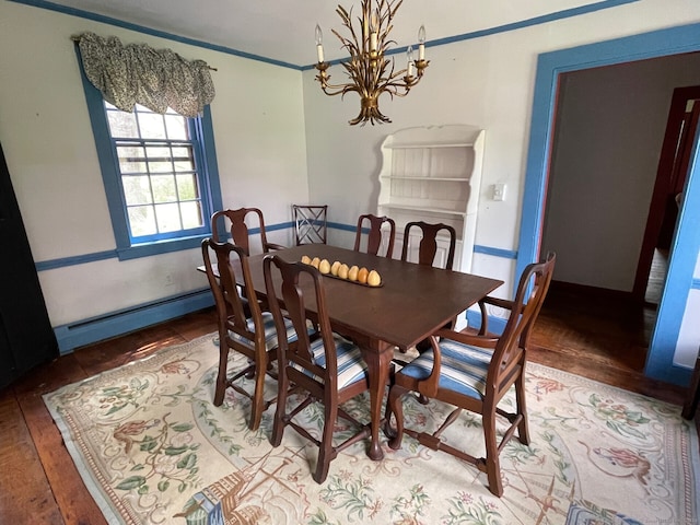 dining space with hardwood / wood-style floors, an inviting chandelier, and a baseboard heating unit