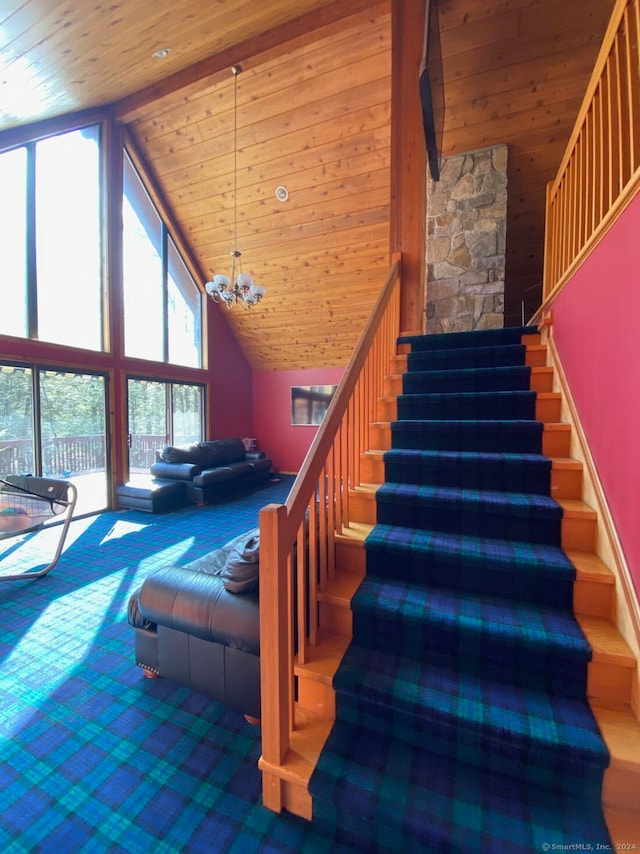 stairway with high vaulted ceiling, an inviting chandelier, and wood ceiling