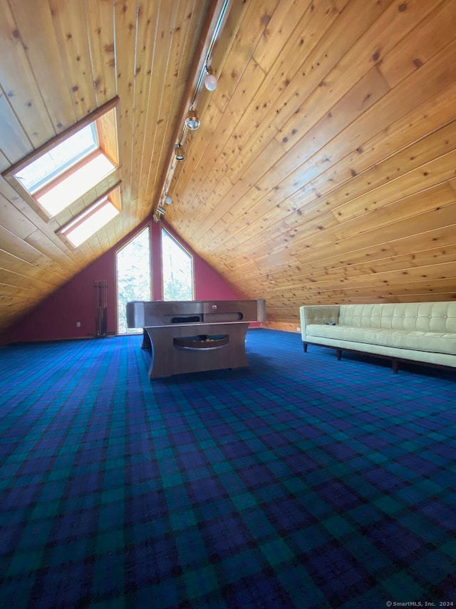 bonus room with vaulted ceiling with skylight and wooden ceiling