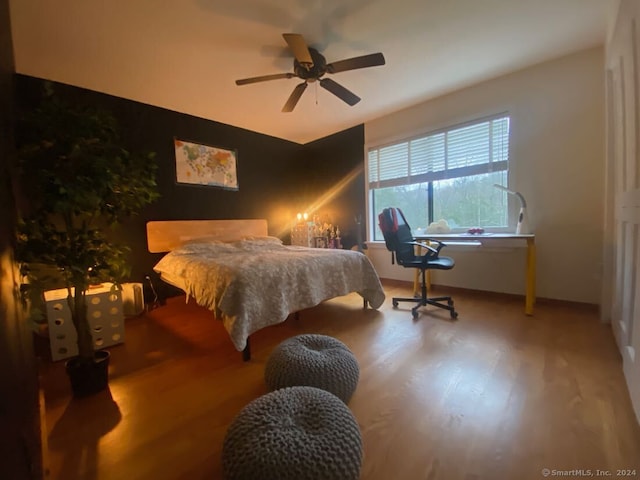 bedroom featuring wood-type flooring and ceiling fan