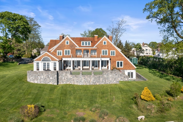 rear view of house with a yard and a patio