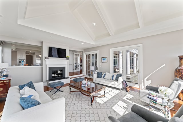 living room featuring french doors, hardwood / wood-style floors, and vaulted ceiling