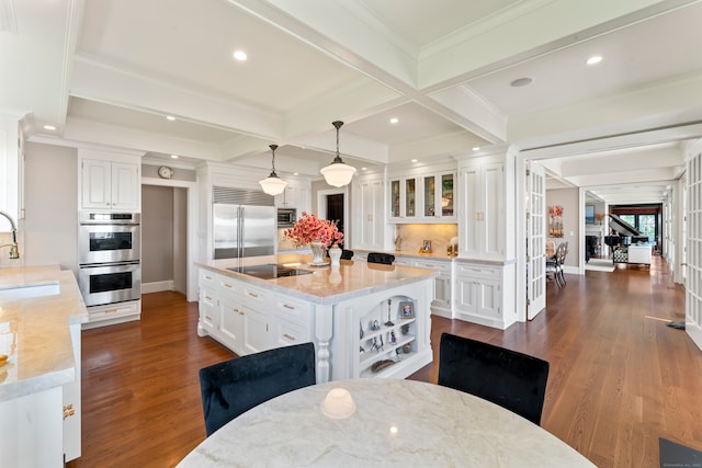 kitchen with pendant lighting, dark hardwood / wood-style floors, white cabinetry, and appliances with stainless steel finishes