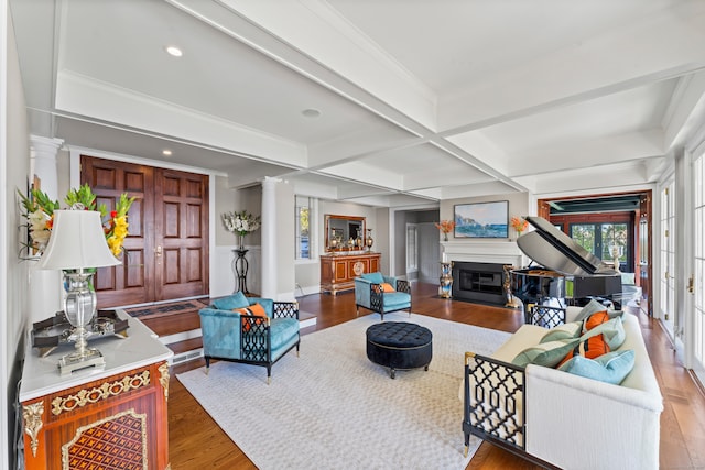 living room featuring beamed ceiling, decorative columns, wood-type flooring, and coffered ceiling