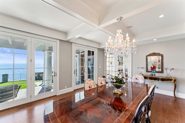 dining area with french doors, dark hardwood / wood-style flooring, beamed ceiling, a water view, and a chandelier