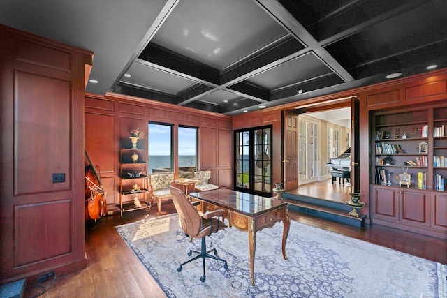 office space featuring a water view, coffered ceiling, hardwood / wood-style flooring, and french doors