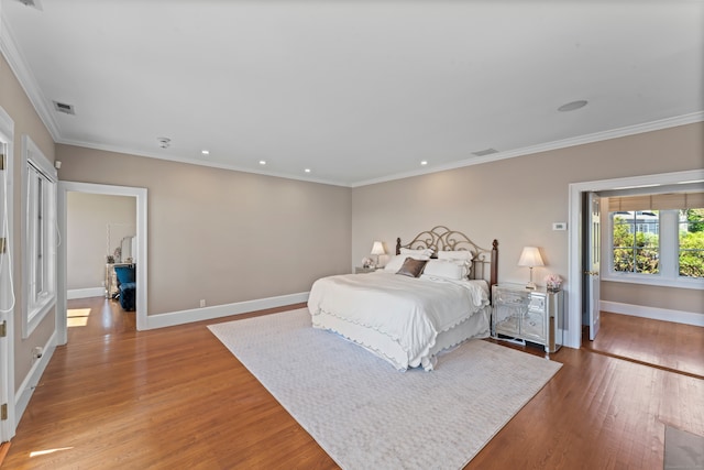 bedroom with crown molding and wood-type flooring