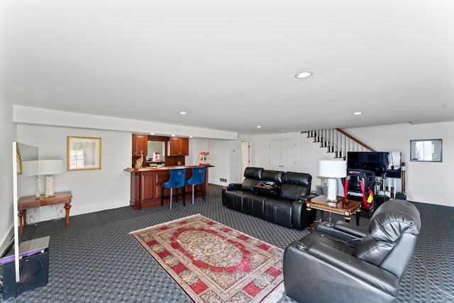 living room with dark colored carpet