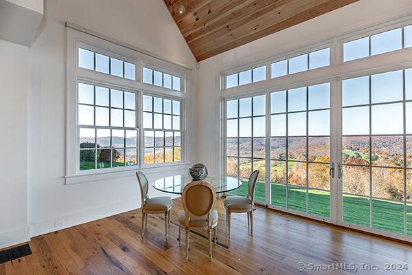 sunroom featuring wooden ceiling and vaulted ceiling