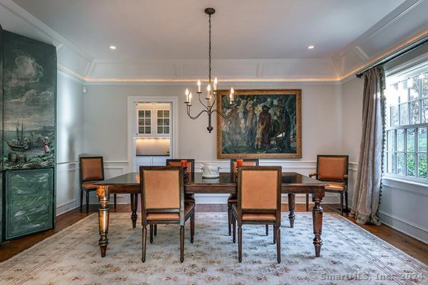 dining space with hardwood / wood-style flooring, a wealth of natural light, and crown molding