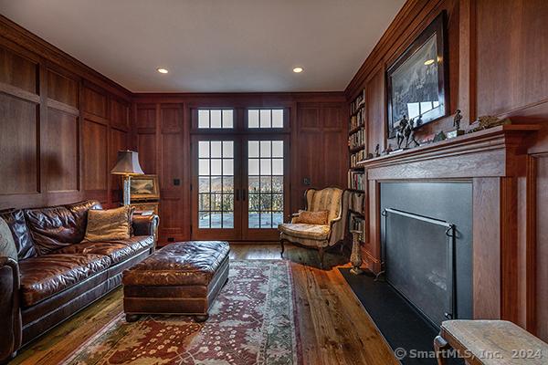 interior space with wood-type flooring, french doors, and wood walls