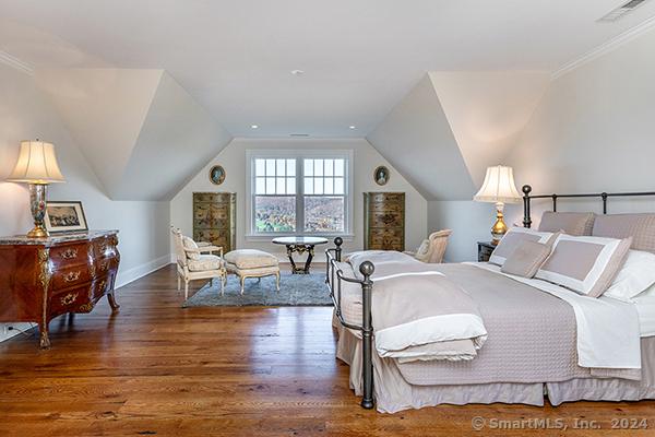 bedroom featuring dark hardwood / wood-style flooring, lofted ceiling, and ornamental molding