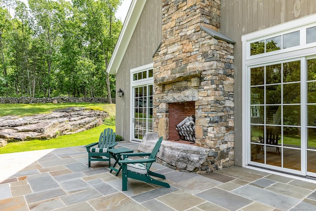 view of patio / terrace featuring an outdoor stone fireplace