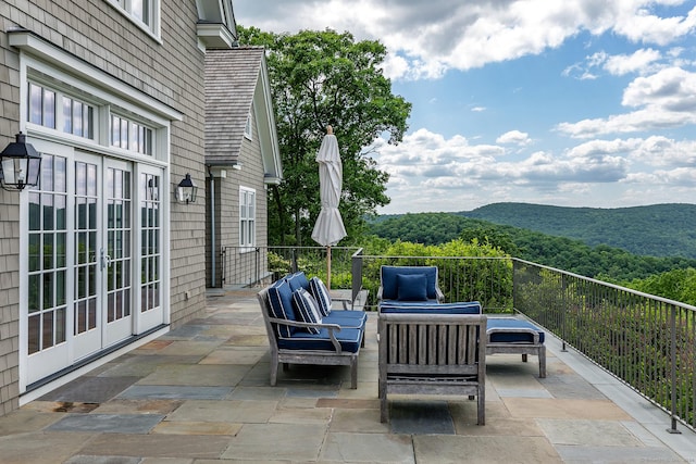 view of patio featuring a mountain view, french doors, and an outdoor hangout area