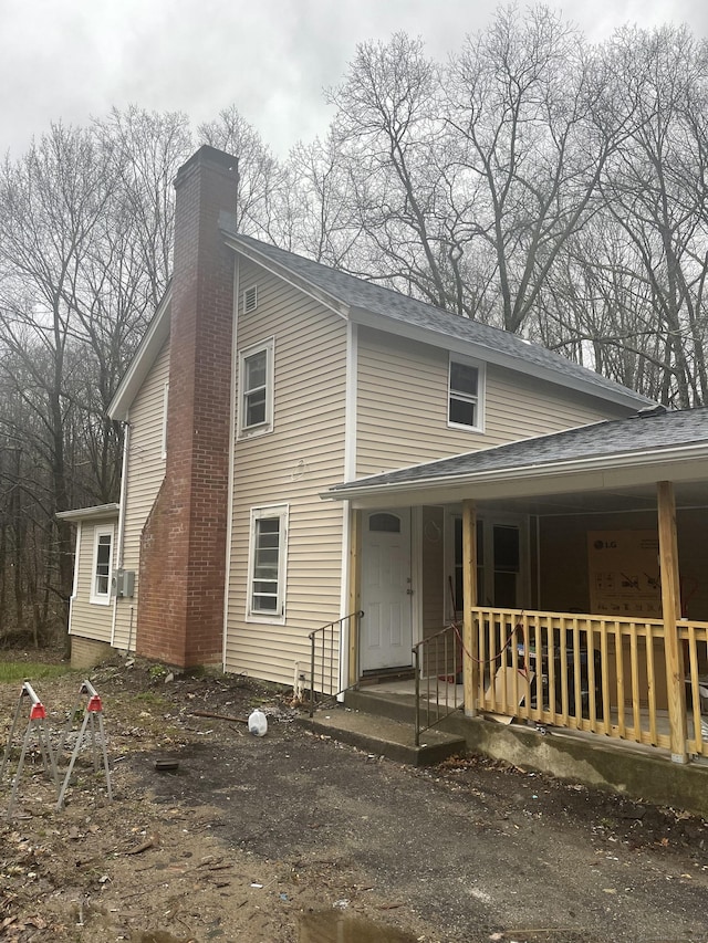 971 New Litchfield St, Torrington, CT 06790 - view of front facade with a porch and a chimney